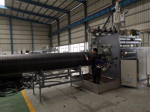 Spiral forming machine producing hollow wall pipes