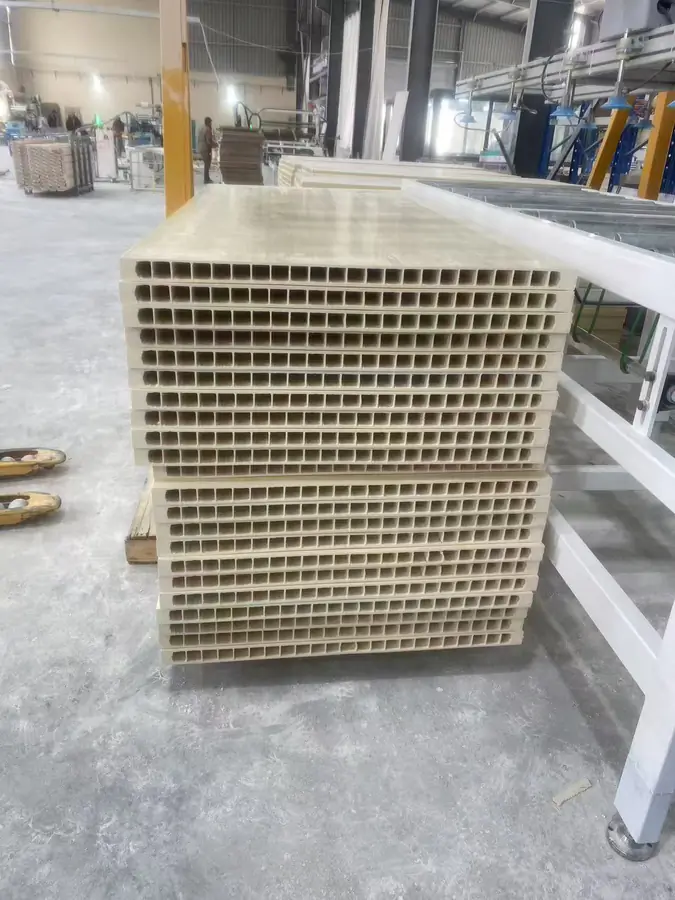 Batch-produced hollow WPC door boards stacked in the workshop