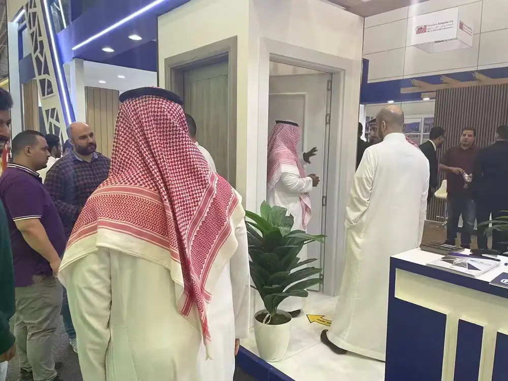 Customers inspecting WPC door panel products at an exhibition
