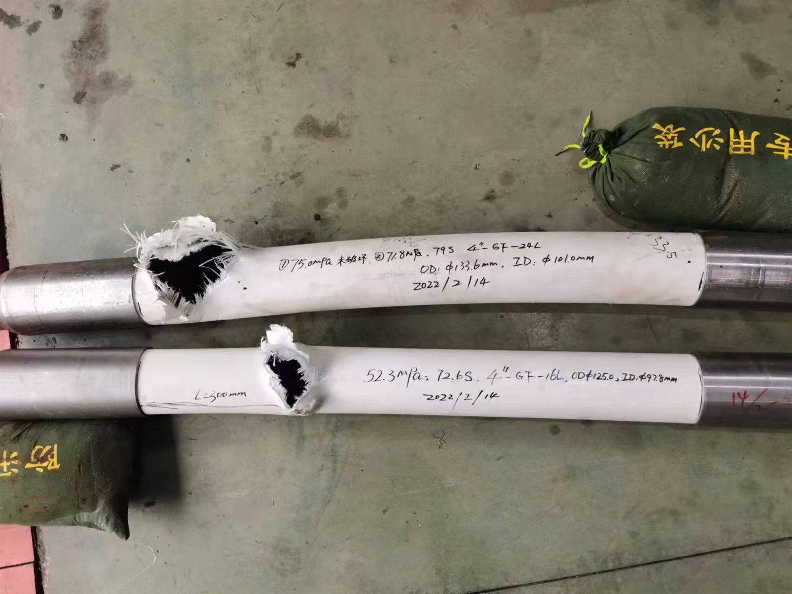 Two tested RTP pipe specimens with handwritten burst-test data and dimensions