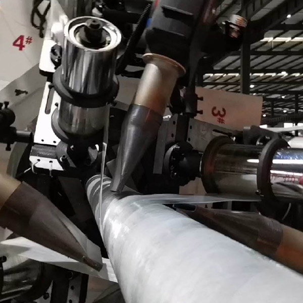 Close-up of multiple reinforcement tapes being applied to an RTP pipe