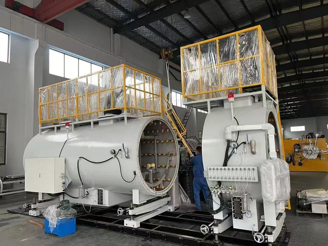 Vacuum sizing and cooling tanks on a plastic pipe extrusion line